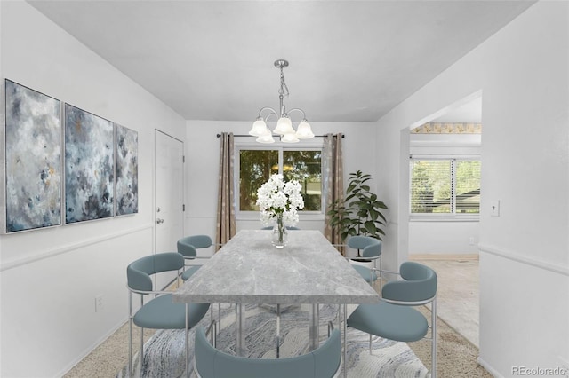 dining space with an inviting chandelier