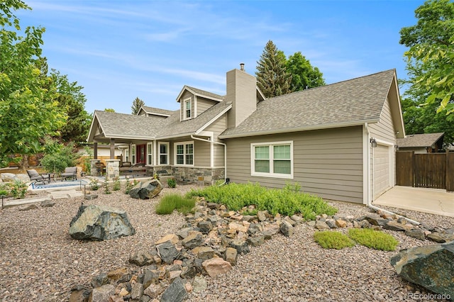 view of front facade featuring a garage and a patio