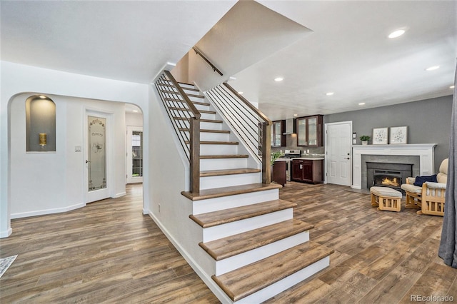 staircase with hardwood / wood-style flooring