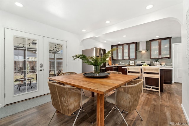 dining space with dark wood-type flooring and french doors