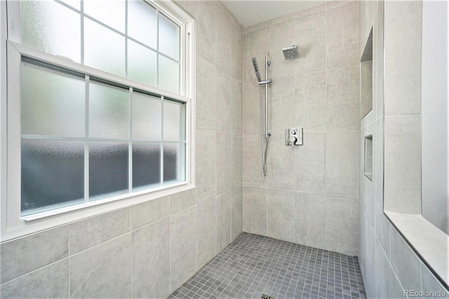 bathroom with a tile shower