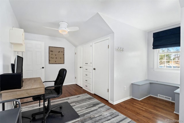 home office with vaulted ceiling, dark wood-type flooring, and ceiling fan