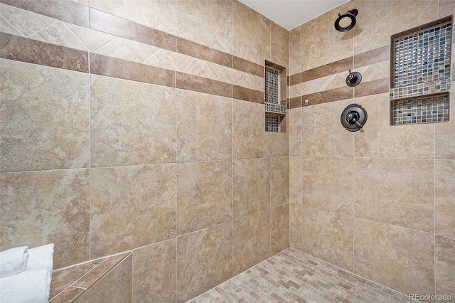 bathroom with tiled shower