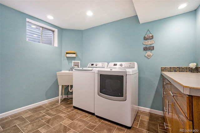 washroom featuring cabinets and washer and dryer