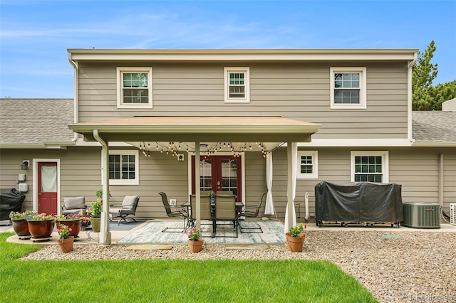 rear view of property featuring a patio area, french doors, and central air condition unit