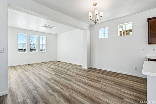 interior space featuring an inviting chandelier and light hardwood / wood-style floors