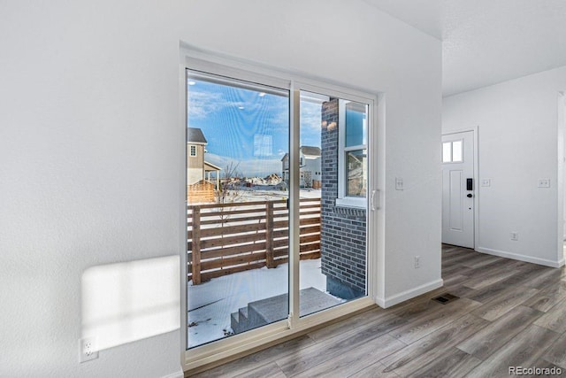 entryway with hardwood / wood-style flooring