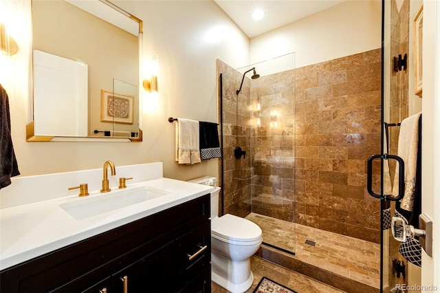 bathroom featuring vanity, toilet, and walk in shower