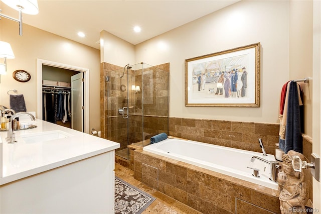 bathroom featuring vanity and independent shower and bath