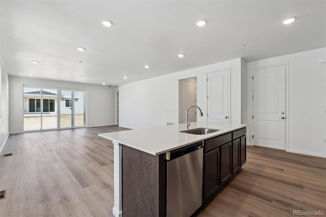 9662 Cathay St, Commerce City, CO 80022 - kitchen with recessed lighting, an island with sink, dishwasher, a sink, and light wood-type flooring
