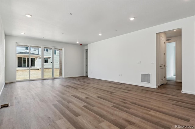 9662 Cathay St, Commerce City, CO 80022 - unfurnished living room with baseboards, wood finished floors, and visible vents
