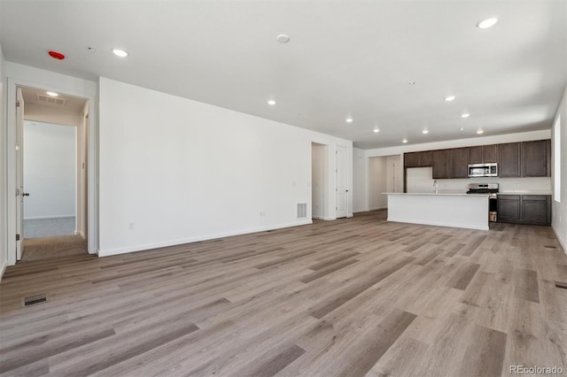 9662 Cathay St, Commerce City, CO 80022 - unfurnished living room featuring recessed lighting, light wood-style floors, and visible vents