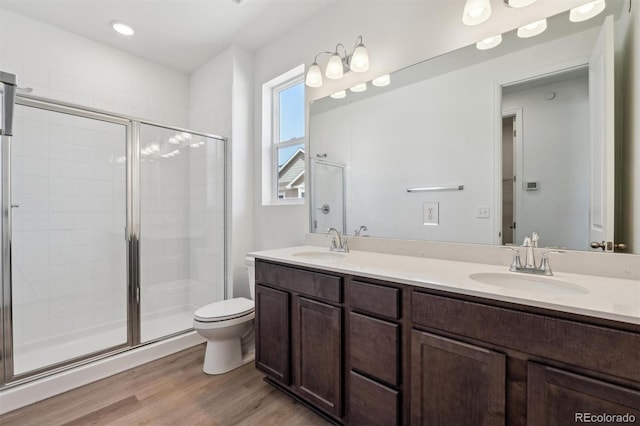 9662 Cathay St, Commerce City, CO 80022 - bathroom with wood finished floors, a stall shower, and a sink