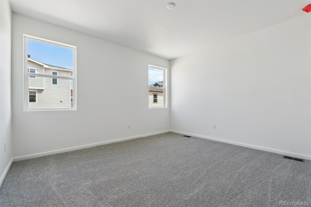 9662 Cathay St, Commerce City, CO 80022 - unfurnished room featuring baseboards, visible vents, carpet floors, and plenty of natural light