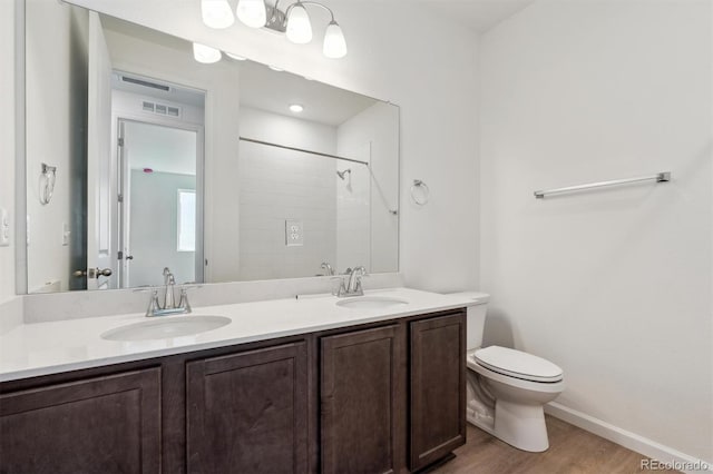9662 Cathay St, Commerce City, CO 80022 - bathroom featuring wood finished floors, visible vents, a sink, and toilet