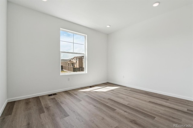 9662 Cathay St, Commerce City, CO 80022 - empty room with visible vents, baseboards, wood finished floors, and recessed lighting