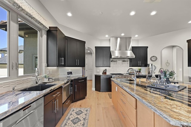 1287 Buffalo Ridge Rd, Castle Pines, CO 80108 - kitchen with extractor fan, stainless steel dishwasher, arched walkways, a sink, and recessed lighting