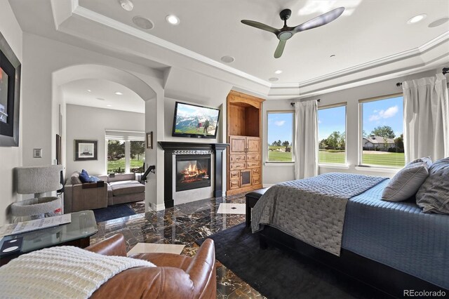 1287 Buffalo Ridge Rd, Castle Pines, CO 80108 - bedroom with marble tiled floors, a raised ceiling, a glass covered fireplace, arched walkways, and recessed lighting