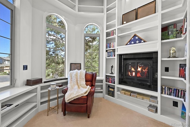 1287 Buffalo Ridge Rd, Castle Pines, CO 80108 - sitting room featuring carpet flooring, a glass covered fireplace, and built in features