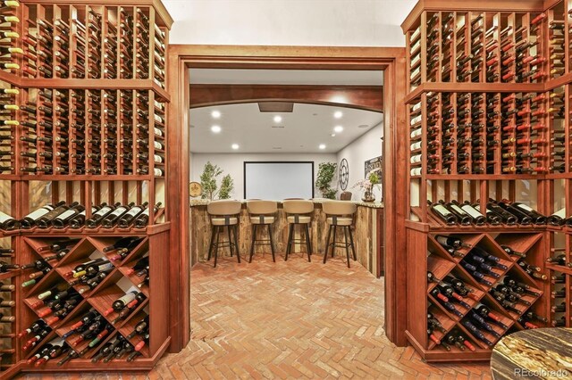 1287 Buffalo Ridge Rd, Castle Pines, CO 80108 - wine cellar featuring brick patterned floors and recessed lighting