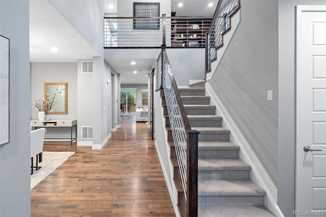 3439 Uinta St, Denver, CO 80238 - entryway featuring wood finished floors, stairway, baseboards, a high ceiling, and recessed lighting