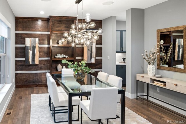 3439 Uinta St, Denver, CO 80238 - dining area with wood finished floors, a chandelier, and baseboards