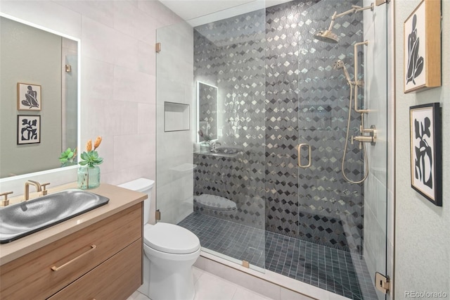 3439 Uinta St, Denver, CO 80238 - bathroom with toilet, tile patterned flooring, vanity, a stall shower, and tile walls