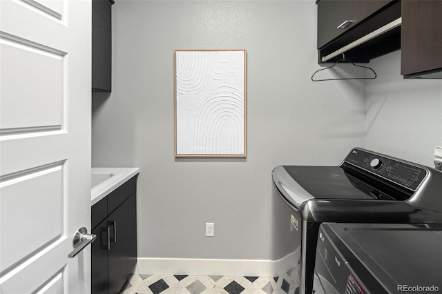 3439 Uinta St, Denver, CO 80238 - washroom with cabinet space, washing machine and clothes dryer, baseboards, and light floors