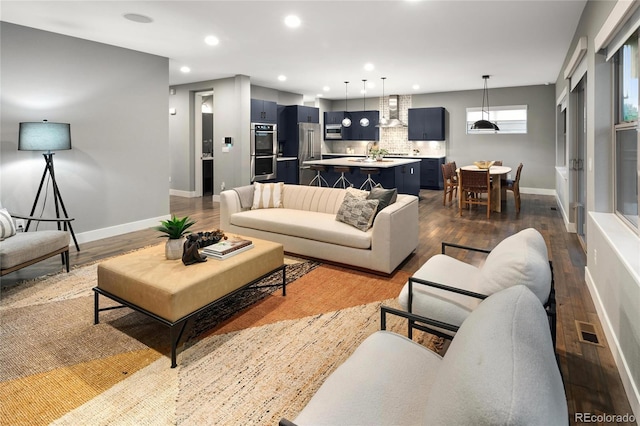 3439 Uinta St, Denver, CO 80238 - living room with dark wood-type flooring, baseboards, and recessed lighting
