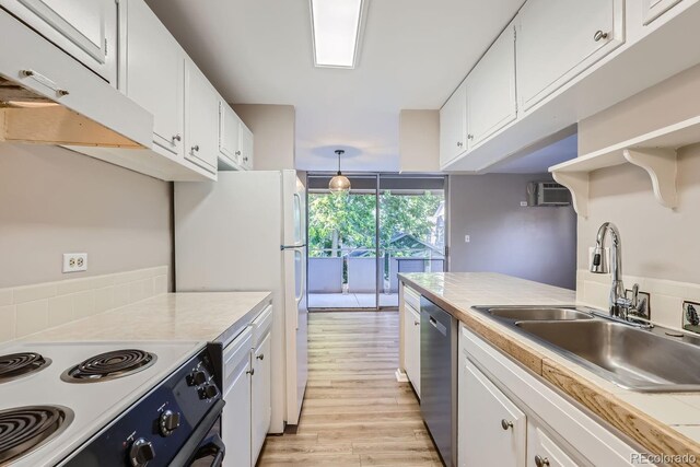 kitchen with dishwasher, light hardwood / wood-style floors, white cabinetry, sink, and stove