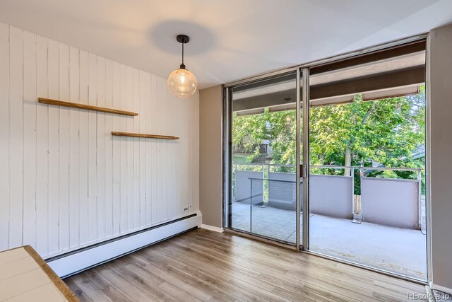 spare room with hardwood / wood-style floors and a baseboard radiator