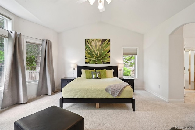 3144 Stevens Cir N, Erie, CO 80516 - bedroom with arched walkways, lofted ceiling, multiple windows, light colored carpet, and a ceiling fan