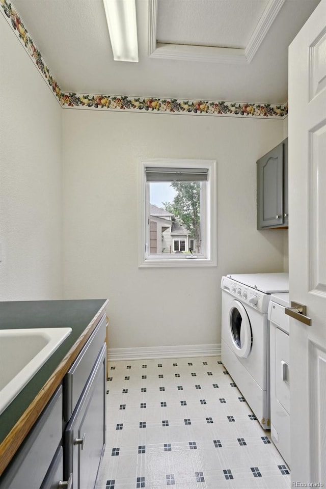 3144 Stevens Cir N, Erie, CO 80516 - laundry area featuring washing machine and clothes dryer, cabinet space, and ornamental molding