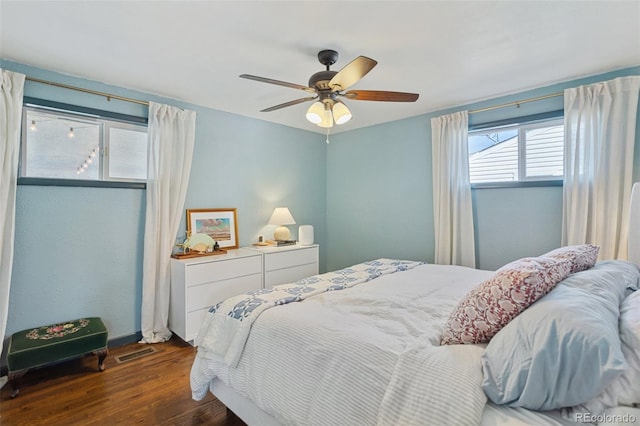 bedroom with visible vents, ceiling fan, and wood finished floors