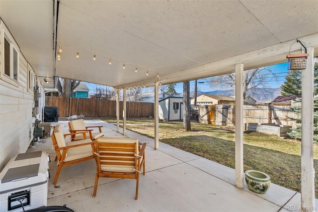 view of patio with an outbuilding and a fenced backyard