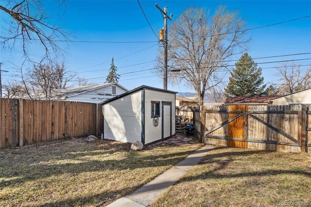 view of shed featuring a gate and a fenced backyard