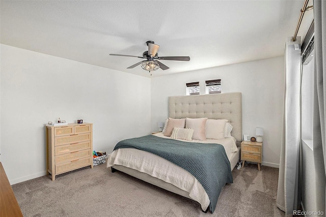 bedroom with baseboards, a ceiling fan, and light colored carpet