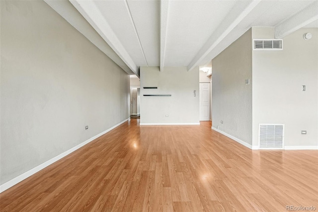 unfurnished living room featuring baseboards, light wood finished floors, and visible vents