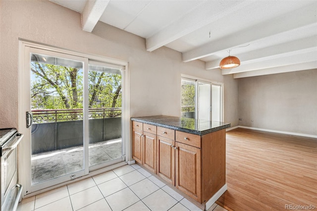 kitchen featuring tile countertops, beam ceiling, stainless steel range with electric cooktop, and a peninsula