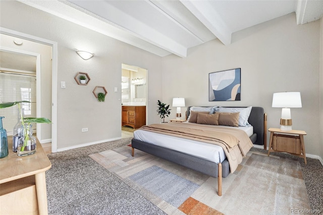 bedroom with baseboards, light carpet, ensuite bath, and beam ceiling