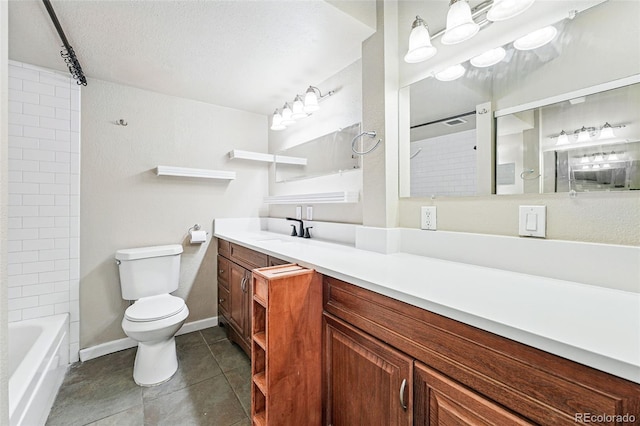 full bath with vanity, toilet, baseboards, a textured ceiling, and tile patterned floors