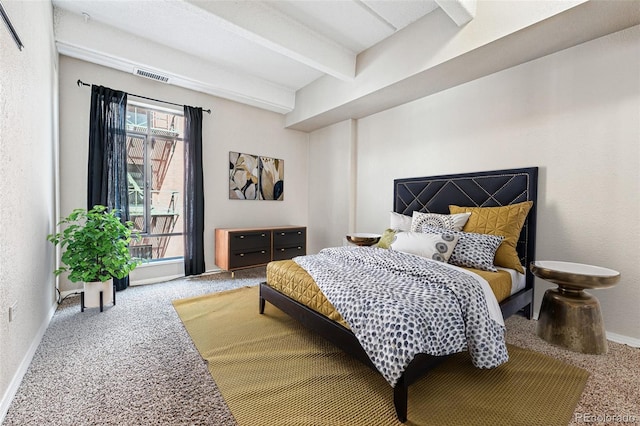 carpeted bedroom with baseboards, beam ceiling, and visible vents