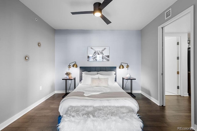 bedroom featuring wood finished floors, baseboards, and ceiling fan
