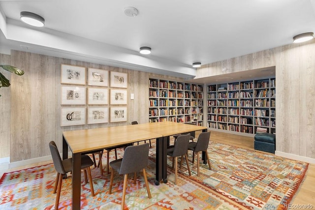 dining area with wood walls and baseboards