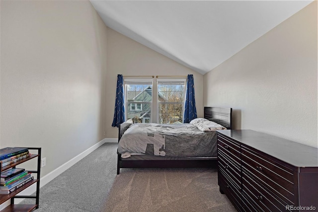 bedroom with vaulted ceiling, carpet flooring, and baseboards