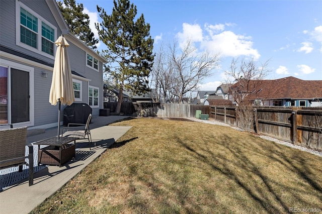 view of yard featuring a patio, a fenced backyard, and a residential view