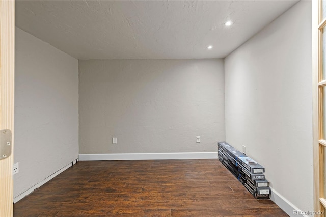 spare room with recessed lighting, baseboards, and wood finished floors