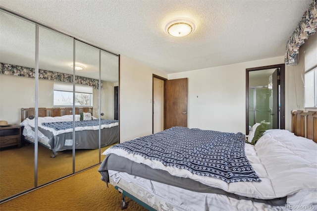 bedroom with a closet, a textured ceiling, and carpet flooring