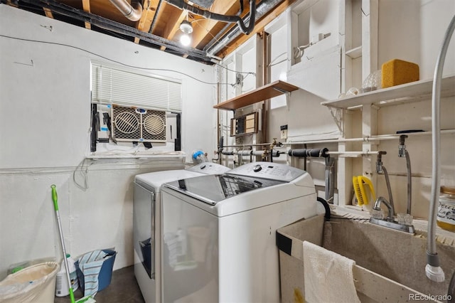 clothes washing area featuring a sink, laundry area, and washer and clothes dryer