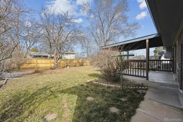 view of yard featuring a wooden deck and fence